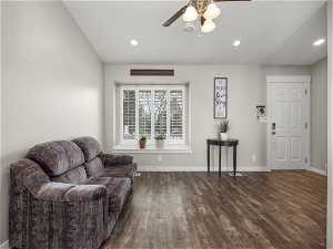 Sitting room with ceiling fan and dark wood-type flooring