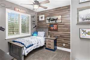 Carpeted bedroom with wood paneling wall