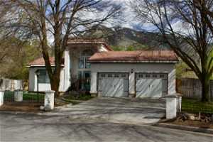 Mediterranean / spanish-style home featuring a garage and a mountain view