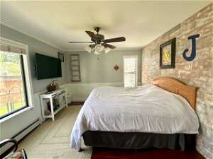 Bedroom with ceiling fan, carpet, and crown molding