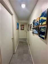 Corridor featuring dark tile flooring