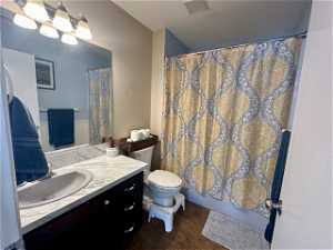 Bathroom with tile flooring, vanity, and toilet
