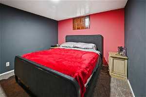 Bedroom with dark colored carpet
