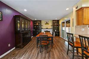 Dining room featuring dark hardwood / wood-style floors and built in shelves