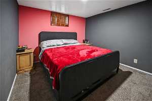 Bedroom featuring dark colored carpet