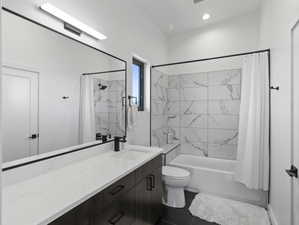 Full bathroom featuring toilet, tile flooring, shower / tub combo with curtain, and large vanity