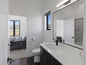 Bathroom featuring tile flooring, vanity, and toilet