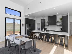 Dining area featuring sink and light wood-type flooring