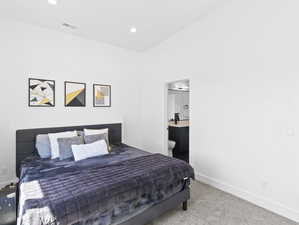 Bedroom with ensuite bath and carpet floors