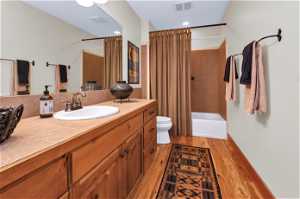 Full bathroom featuring hardwood floors