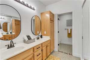 Bathroom featuring tile floors and double vanity