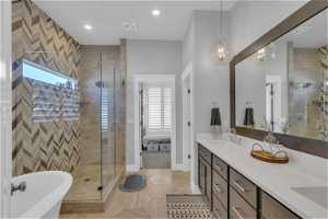 Bathroom with tile floors, dual vanity, and separate shower and tub