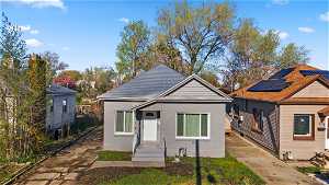 Bungalow-style home with solar panels