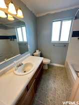 Full bathroom featuring linoleum flooring, a , toilet,  shower combination, and vanity