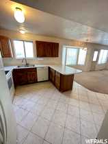Kitchen featuring  natural light, kitchen peninsula, and  tile floors,