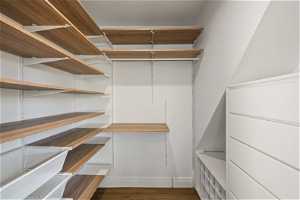 Spacious closet featuring white oak hardwood flooring