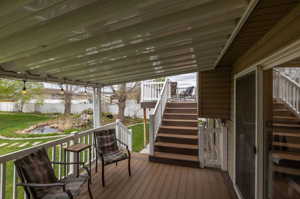 Wooden terrace featuring a lawn