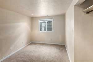 Basement bedroom with a textured ceiling