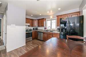 Kitchen featuring sink, appliances with stainless steel finishes, and dark hardwood / wood-style floors