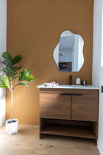 Room details featuring vanity and light wood-type flooring