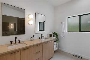 Bathroom featuring double sink vanity and tile flooring
