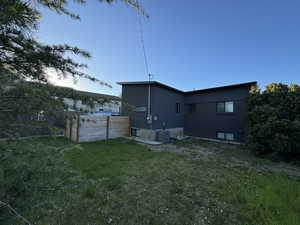 Rear view of property with fenced in yard