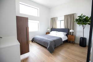 Bedroom with light hardwood / wood-style floors