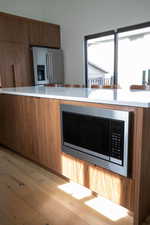 Kitchen featuring plenty of natural light, stainless steel appliances, and light wood-type flooring