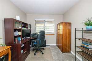 Home office featuring light colored carpet