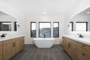 Bathroom featuring vanity, a bathtub, and tile patterned floors