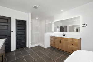 Bathroom with vanity, plus walk in shower, and tile patterned floors