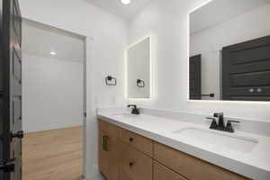 Bathroom with vanity and hardwood / wood-style flooring