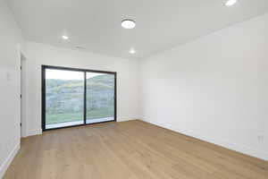 Unfurnished room with light hardwood / wood-style flooring