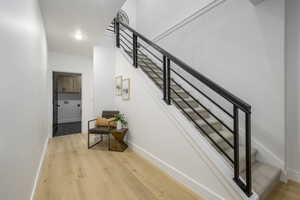 Stairway featuring hardwood / wood-style floors