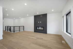 Unfurnished living room featuring a fireplace and light wood-type flooring