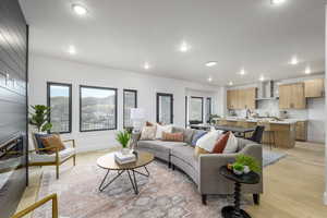 Living room with light hardwood / wood-style flooring and plenty of natural light