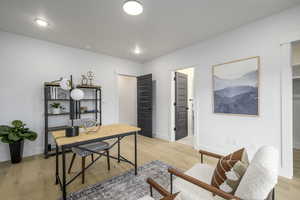 Office area with light wood-type flooring