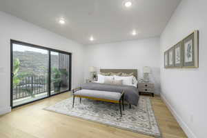 Bedroom featuring access to exterior and light hardwood / wood-style floors