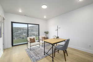 Office space with light hardwood / wood-style floors