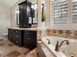 En-suite master bath with double vanity and a beautiful jetted tub and a walk-in shower