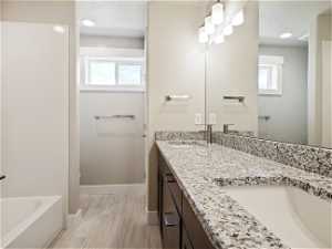 Bathroom featuring double vanity and tile flooring
