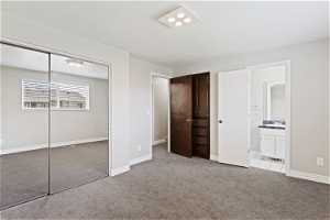 Unfurnished bedroom with ensuite bath, light tile floors, and a closet