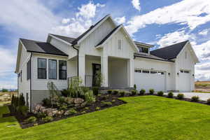 Modern inspired farmhouse featuring a front lawn and a garage -- Note: This Is Not The Subject Property Itself