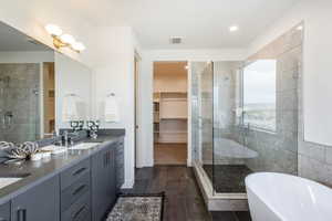 Bathroom featuring tile walls, double vanity, tile flooring, and separate shower and tub. Note: This Is Not The Subject Property Itself