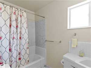 Full bathroom with vanity, shower / bath combo, and toilet