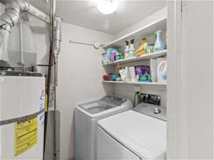 Clothes washing area featuring independent washer and dryer, washer hookup, and gas water heater