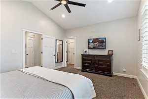 Bedroom with high vaulted ceiling, ceiling fan, and carpet