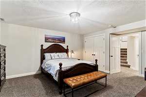 Carpeted spacious bedroom with a closet