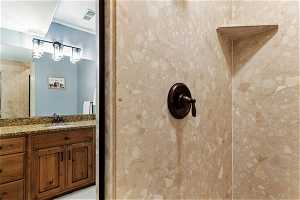 Basement Bathroom featuring walk in shower and vanity