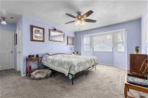 Master Bedroom featuring light colored carpet, a textured ceiling, and ceiling fan